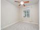 This bedroom features neutral colored walls, carpeted floor, a ceiling fan, and window with light-filtering curtains at 307 Millbrook Dr, Pittsboro, NC 27312