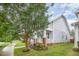 Charming two-story home featuring a covered porch, brick accents, a well-manicured lawn, and mature trees at 307 Millbrook Dr, Pittsboro, NC 27312