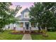 Charming two-story home with a welcoming front porch, manicured lawn, and beautiful landscaping at 307 Millbrook Dr, Pittsboro, NC 27312