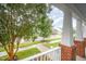 Inviting front porch with brick pillars, a white railing, and a view of the street and neighboring homes at 307 Millbrook Dr, Pittsboro, NC 27312