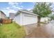 Detached garage with a clean white door, surrounded by lush greenery and a well-maintained lawn at 307 Millbrook Dr, Pittsboro, NC 27312