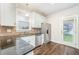 Modern kitchen with granite countertops, stainless steel appliances, and hardwood floors for a sleek look at 307 Millbrook Dr, Pittsboro, NC 27312
