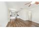 Open-concept living area with hardwood floors, seamlessly connecting to a modern kitchen and dining area at 307 Millbrook Dr, Pittsboro, NC 27312