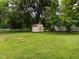 Spacious backyard with a storage shed offering potential for outdoor activities and gardening at 307 Sunset Dr, Elon, NC 27244