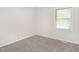 A carpeted bedroom with a window at 307 Sunset Dr, Elon, NC 27244