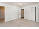 Bright bedroom featuring neutral carpet, a ceiling fan, and closet with bi-fold doors at 307 Sunset Dr, Elon, NC 27244