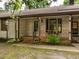 Inviting front porch with brick steps and wood railing at 307 Sunset Dr, Elon, NC 27244