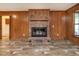 Living room showcasing a brick fireplace and wood-style flooring at 307 Sunset Dr, Elon, NC 27244