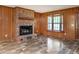 Cozy living room with brick fireplace and large bay window at 307 Sunset Dr, Elon, NC 27244