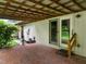 Enclosed brick patio featuring wood beams and access to backyard, creating a great outdoor living space at 307 Sunset Dr, Elon, NC 27244