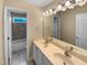 Well-lit bathroom with double vanity, large mirror, and tile flooring leading to a combined shower and tub at 3116 Kirby St, Durham, NC 27713