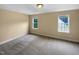 Cozy bedroom featuring neutral carpet, fresh paint, and bright windows with natural light, creating a comfortable retreat at 3116 Kirby St, Durham, NC 27713