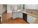 Cozy kitchen features white cabinets and a sink at 3116 Kirby St, Durham, NC 27713