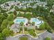 Aerial view of the community pool, clubhouse, and amenities, all surrounded by trees at 324 Waterford Lake Dr, Cary, NC 27519