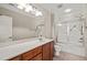 Bathroom with vanity, large mirror and bath/shower combination with glass doors at 324 Waterford Lake Dr, Cary, NC 27519