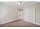 Well-lit bedroom features neutral tones, a ceiling fan and an adjoining closet at 324 Waterford Lake Dr, Cary, NC 27519