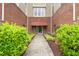 Condo entrance with brick walls, decorative landscaping, and a well-maintained walkway at 324 Waterford Lake Dr, Cary, NC 27519