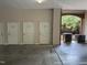 Unit entrances in a covered parking garage with access to additional AC unit and landscaping views at 324 Waterford Lake Dr, Cary, NC 27519