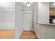 Hallway view featuring wood flooring, white trim, and access to various rooms at 324 Waterford Lake Dr, Cary, NC 27519