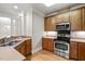 Updated kitchen boasts stainless steel appliances, wooden cabinets, and modern fixtures at 324 Waterford Lake Dr, Cary, NC 27519