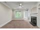 Cozy living room with fireplace, large windows and an open doorway to adjacent rooms at 324 Waterford Lake Dr, Cary, NC 27519