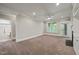 Inviting living room with natural light from large windows and an open doorway to an adjacent bathroom at 324 Waterford Lake Dr, Cary, NC 27519