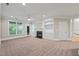 Spacious living room featuring a fireplace, built-in shelving, and access to outdoor views at 324 Waterford Lake Dr, Cary, NC 27519