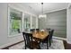 Elegant dining room with a decorative green wall, a chandelier, and large windows at 369 Roberts Ridge Dr, Cary, NC 27513