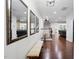 Bright foyer with hardwood floors, a bench, decorative mirrors, and a staircase at 369 Roberts Ridge Dr, Cary, NC 27513