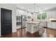 Well-lit kitchen featuring stainless steel appliances, granite countertops, and a kitchen island at 369 Roberts Ridge Dr, Cary, NC 27513