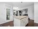 Open kitchen with an island that connects to living spaces and access to a sunroom at 369 Roberts Ridge Dr, Cary, NC 27513
