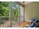 Inviting screened-in porch with wood floors, comfortable seating, and scenic views of the trees at 369 Roberts Ridge Dr, Cary, NC 27513