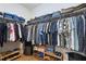 Organized walk-in closet with ample hanging space and shelving for clothing and shoe storage at 369 Roberts Ridge Dr, Cary, NC 27513