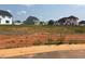 View of the Adams Homes community showing an empty lot ready to build with other homes in the background at 39 Braddock Ct, Garner, NC 27529