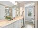 Bathroom with white cabinets, a large mirror, decor, and a view to another room at 40 Breckenridge Pl, Dunn, NC 28334