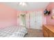 Bedroom with double closets, dresser, tv, and bed with patterned linens at 40 Breckenridge Pl, Dunn, NC 28334
