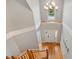 Elevated view of a grand foyer showcasing hardwood flooring, elegant lighting, and a staircase with white railings at 40 Breckenridge Pl, Dunn, NC 28334