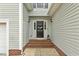 Close-up of the home's front door with wreath, sidelights, and brick steps at 40 Breckenridge Pl, Dunn, NC 28334
