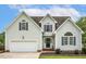 Charming two-story home features a manicured lawn, attached garage, and classic architectural details at 40 Breckenridge Pl, Dunn, NC 28334