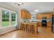 Open kitchen with island seating, hardwood floors, and ample natural light at 40 Breckenridge Pl, Dunn, NC 28334