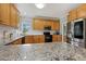 Bright kitchen featuring granite countertops, stainless steel appliances, and light wood cabinetry at 40 Breckenridge Pl, Dunn, NC 28334