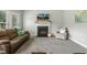 Living room with fireplace, plush carpeting, and large windows at 40 Breckenridge Pl, Dunn, NC 28334