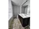 Bathroom featuring a double sink vanity and a tiled tub and shower at 401 Coalinga Ln # 106, Raleigh, NC 27610