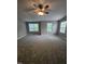 Large bedroom with neutral walls, plush carpet, and great natural lighting from the windows at 401 Coalinga Ln # 106, Raleigh, NC 27610