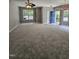 Open-concept living room with lots of natural light, a ceiling fan and blue front door at 401 Coalinga Ln # 106, Raleigh, NC 27610