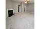 Living room features plush gray carpet, a corner fireplace, and neutral wall color at 401 Coalinga Ln # 106, Raleigh, NC 27610