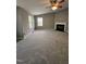 Spacious living room with neutral walls, plush carpet, and a corner fireplace for a cozy atmosphere at 401 Coalinga Ln # 106, Raleigh, NC 27610
