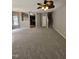 Spacious living room with a ceiling fan, open floor plan leading to the kitchen, and staircase access at 401 Coalinga Ln # 106, Raleigh, NC 27610