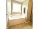 Soothing bathroom with a large soaking tub and natural light from a frosted window at 411 Joneshaven Dr, Fuquay Varina, NC 27526