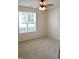 Cozy bedroom with neutral carpet and a window with blinds, offering a serene and simple space at 411 Joneshaven Dr, Fuquay Varina, NC 27526